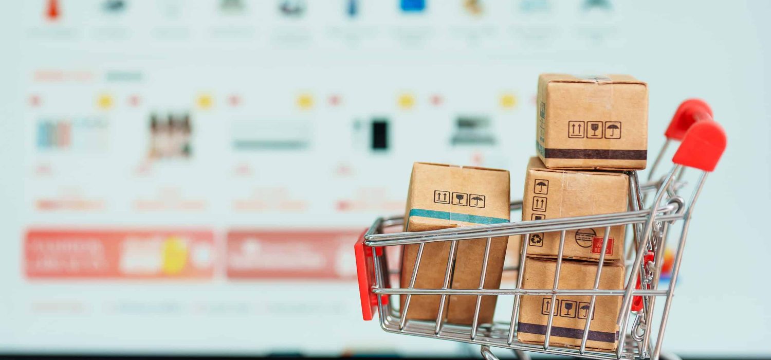 Boxes with shopping cart on a laptop computer. online shopping, Marketplace platform website, technology, ecommerce, shipping delivery, logistics and online payment concepts