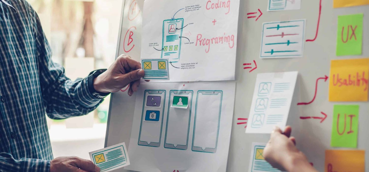 Designer team drawing website ux app development application for mobile phone.