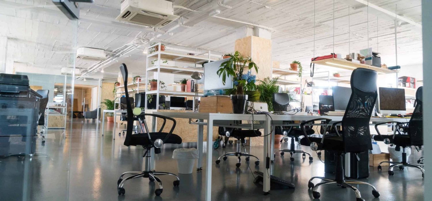 Shot of an industrial looking working space with multiple empty seats .