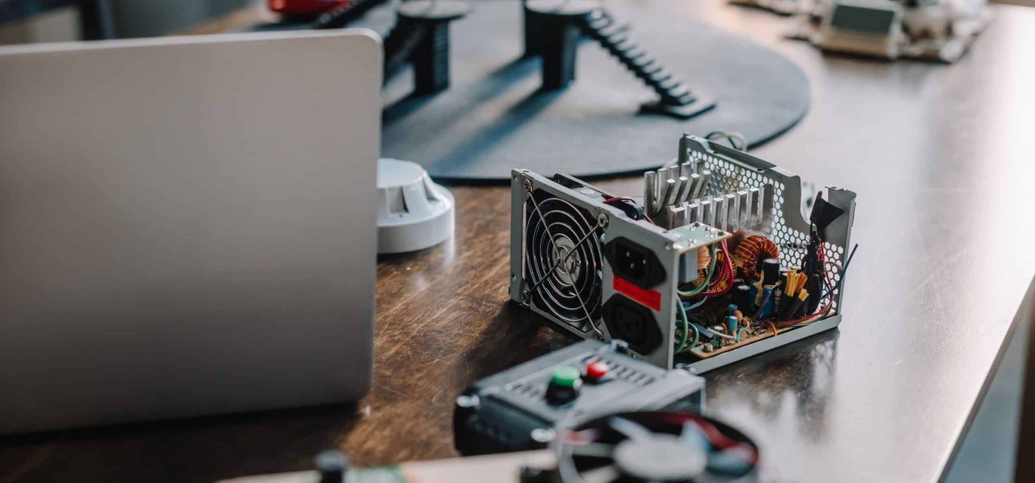 laptop and technical parts of pc on tabletop at home