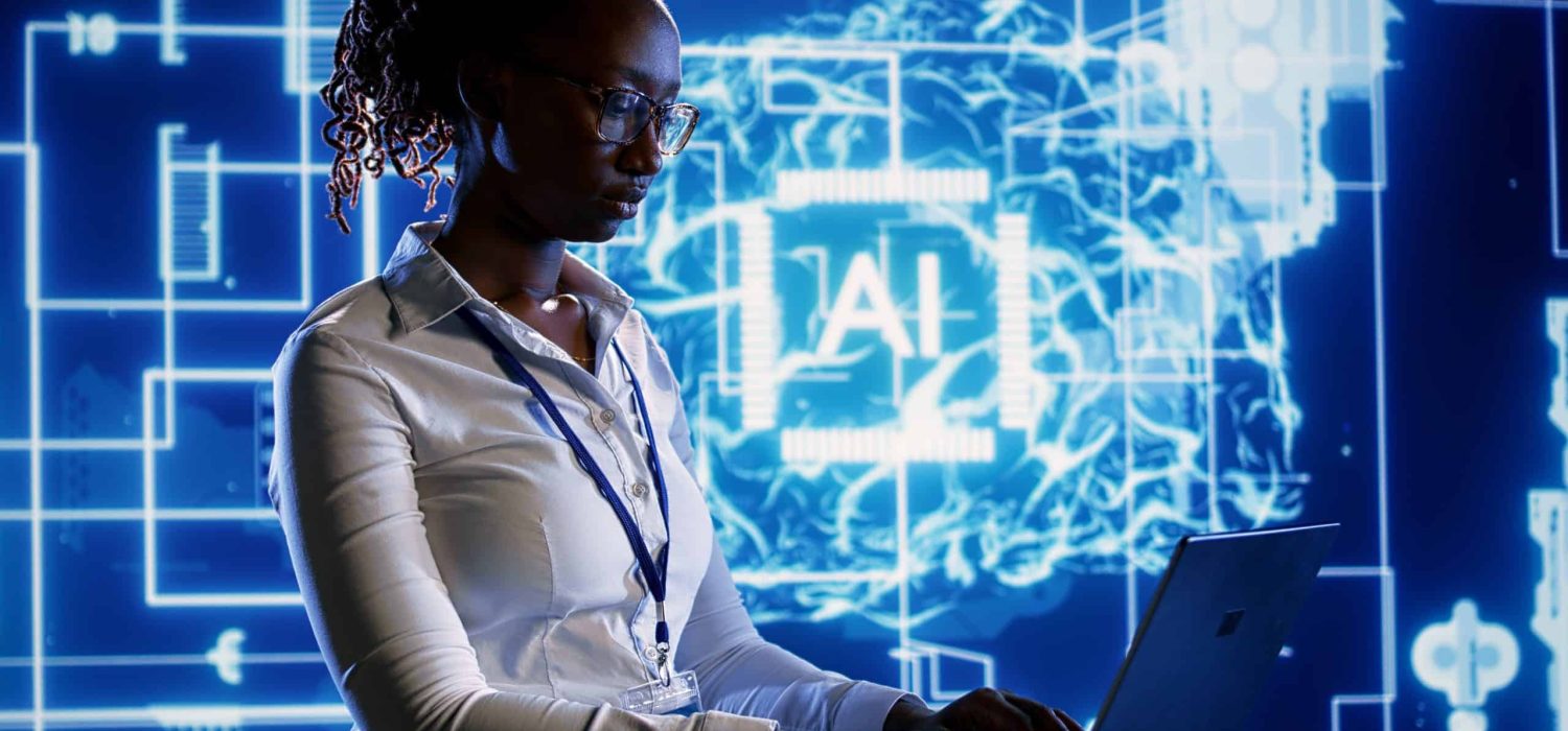 Trained specialist using laptop to maintenance artificial intelligence neural networks made up of interconnected nodes. System administrator using AI system aiding in processing information